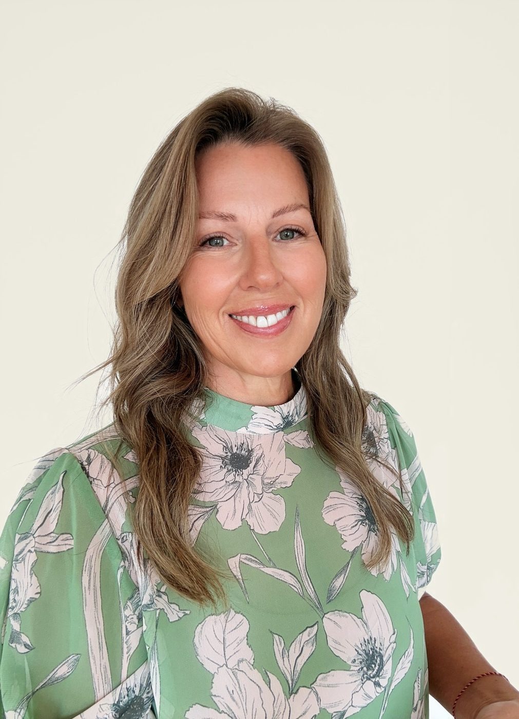 Teena Dunn in a green floral top, host of the free miscarriage masterclass